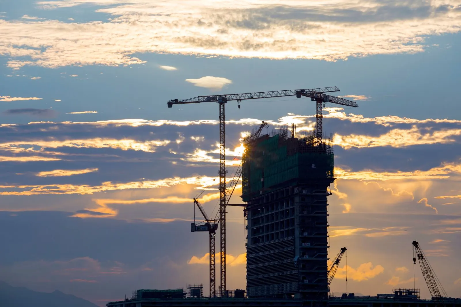 Commercial building exterior under construction at dusk